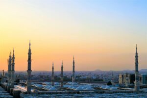 Stunning view of the Prophet's Mosque minarets at sunset in Medina, Saudi Arabia.