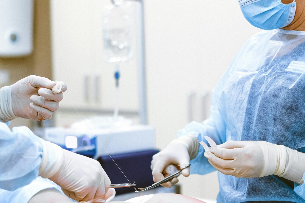 Healthcare professionals in protective gear engaged in a surgical procedure.